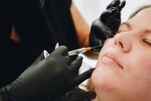 A woman is taking Sculptra injection. 